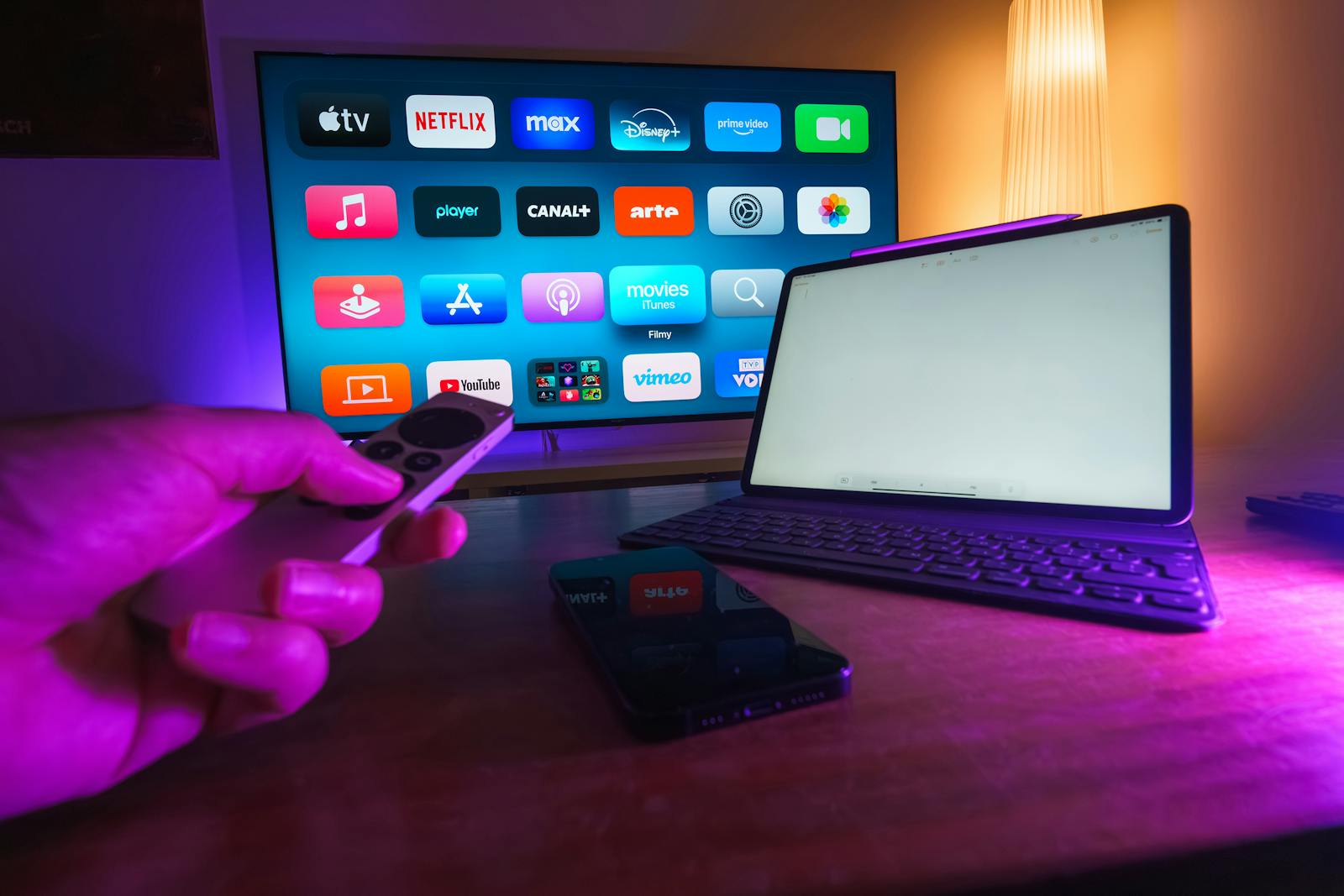 Photo by Jakub Zerdzicki A cozy home setup featuring streaming services on smart TV, tablet, and smartphone.