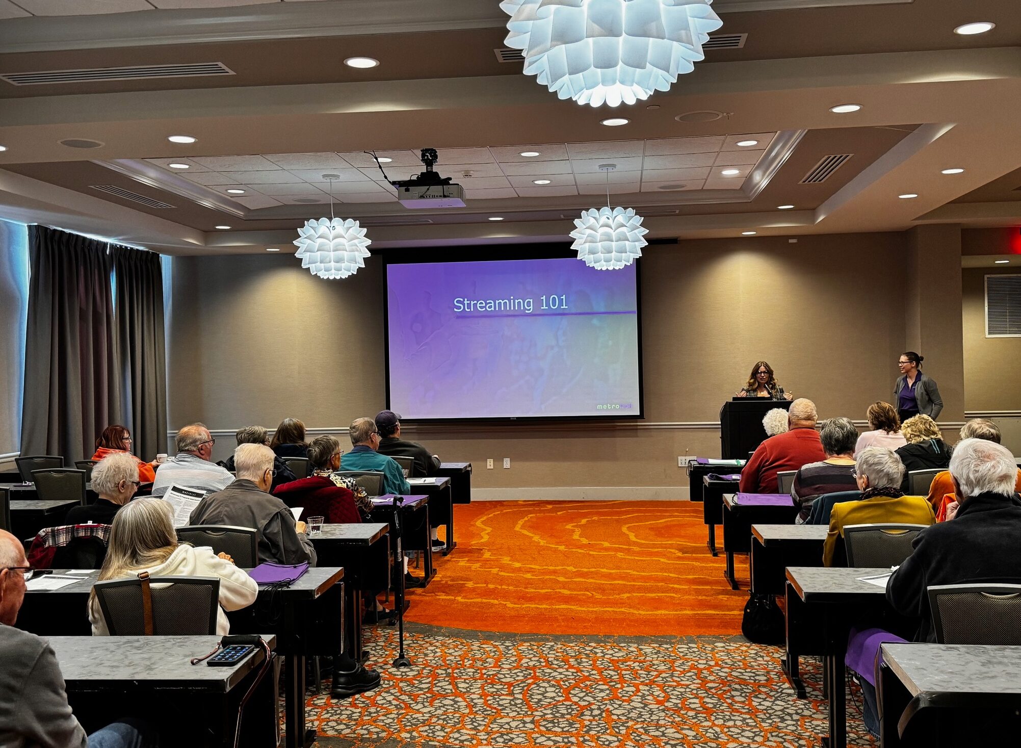 Streaming Seminar A cozy home setup featuring streaming services on smart TV, tablet, and smartphone.